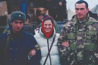 56.Armed escort protecting the team as they distribute food parcels at the tent refugee camp
